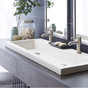 Pearl white rectangular trough bathroom sink with two faucet holes and chrome fixtures.