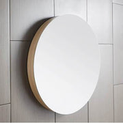Round wall mirror with white reflective surface and natural wood-tone frame mounted on white shiplap wall.