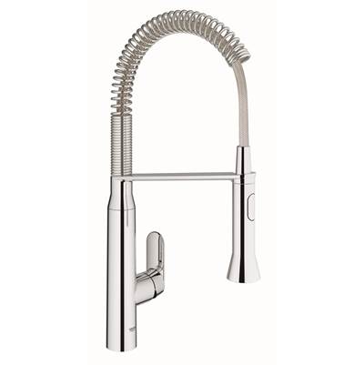 Chrome single-handle kitchen faucet with flexible coiled spray hose and tall arched spout.