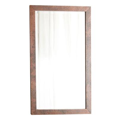 Rectangular wall mirror with hammered copper-finish frame in antique patina, 28 x 40 inches.