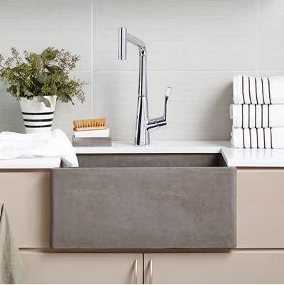 Ash gray rectangular farmhouse kitchen sink with chrome pull-down faucet, displayed in a countertop setting with white subway