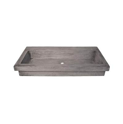 Rectangular gray concrete trough sink with sloped sides and single drain hole, no faucet holes.