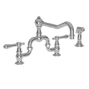 Satin nickel bridge kitchen faucet with curved spout, two handles, and separate side spray attachment.