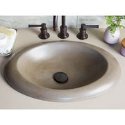 Earth-toned round drop-in sink with three bronze faucet handles and matching drain cap.
