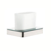 Brushed nickel toothbrush holder with white ceramic cup on glass and metal base.