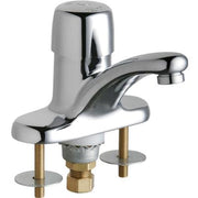Chrome single-handle metering sink faucet with curved spout and brass supply lines on deck plate.