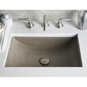 Rectangular undermount bathroom sink with earth-tone finish, dual faucet holes, and center drain opening.