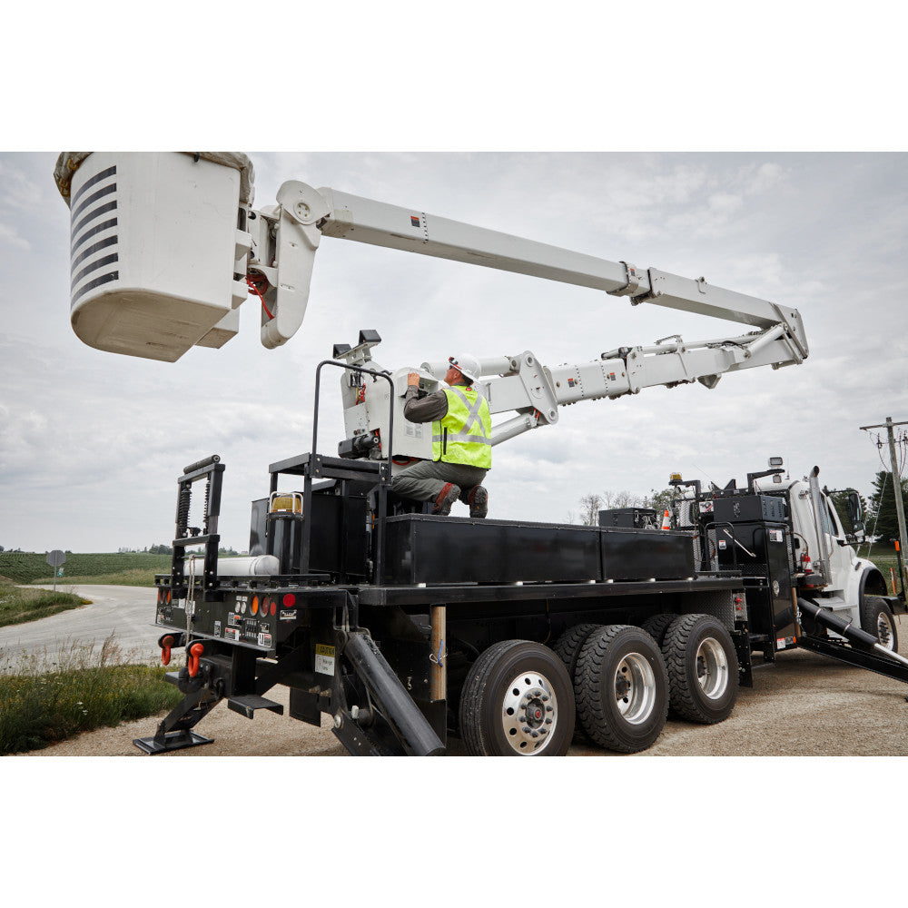 Worker wearing bright yellow high-visibility safety vest on utility truck with extended boom arm.