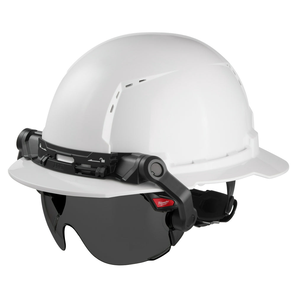 Tinted dark visor attachment mounted on white safety helmet with black hinged arms and Milwaukee branding.