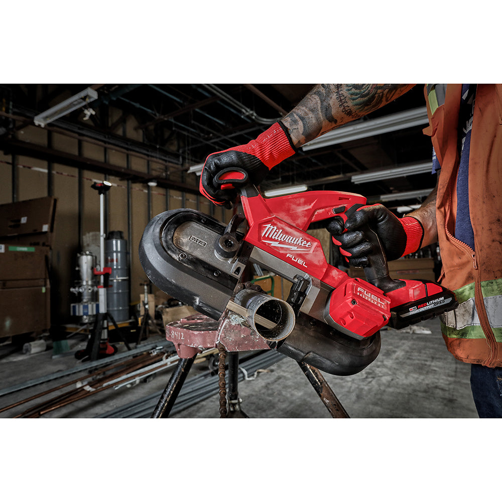 Red and black protective covers installed on Milwaukee compact band saw blade and wheel assembly.