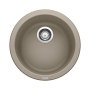 Truffle-colored round undermount bar sink with single basin and chrome drain strainer, viewed from above.