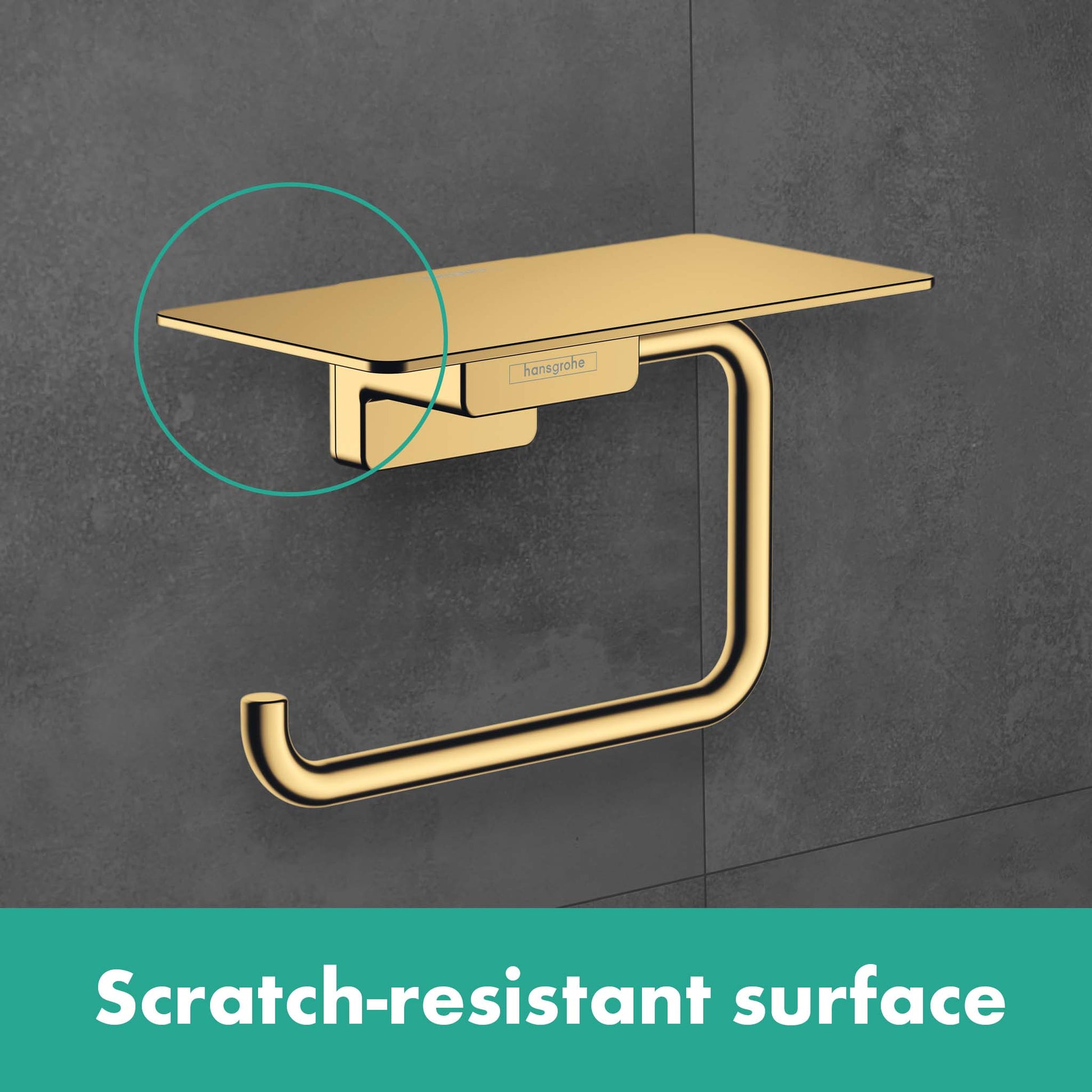 Brushed bronze toilet paper holder with shelf mounted on gray tile wall.