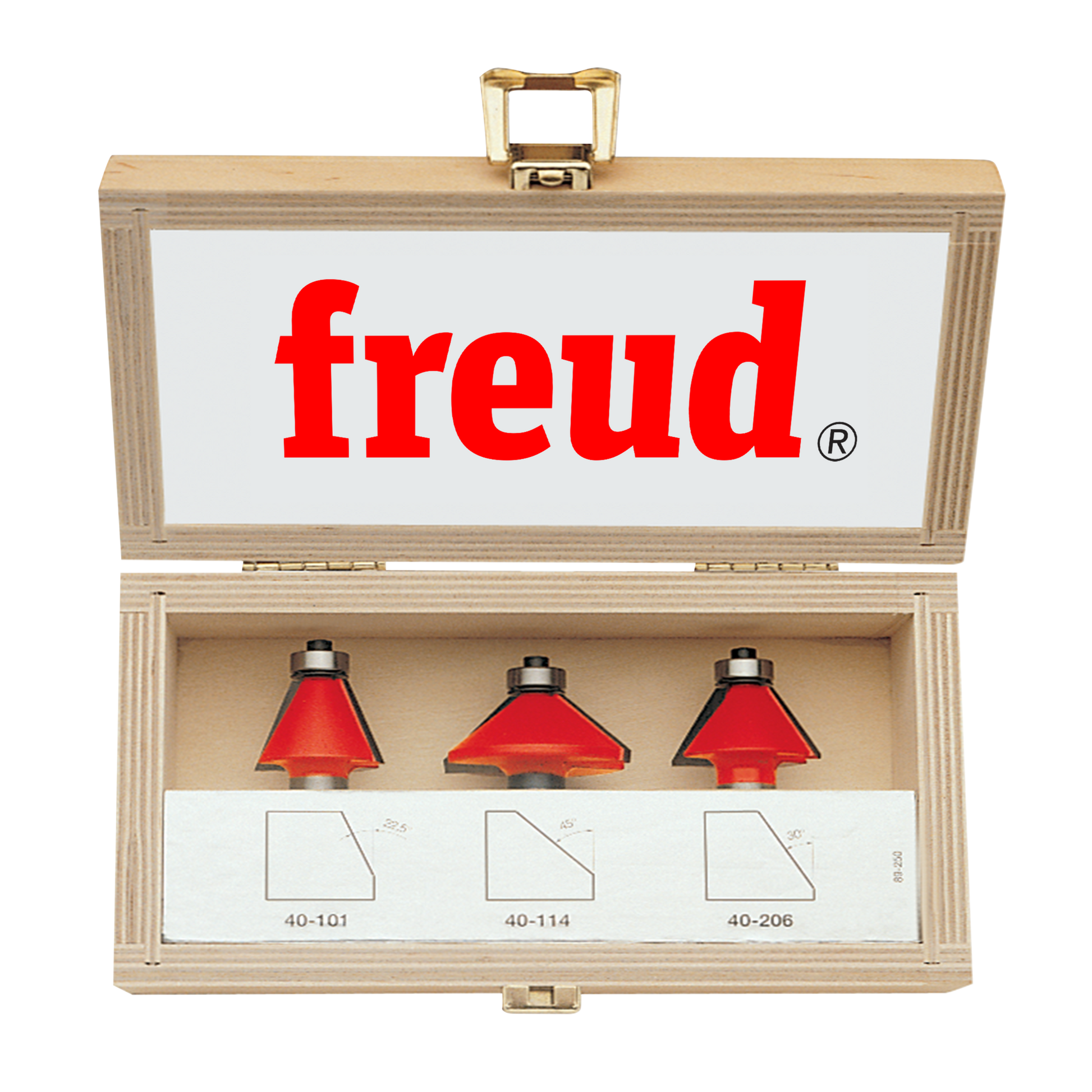 Three red chamfer router bits with metal shanks in a wooden Freud storage box.