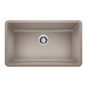 Truffle-colored single undermount kitchen sink with rounded corners and chrome drain strainer viewed from above.