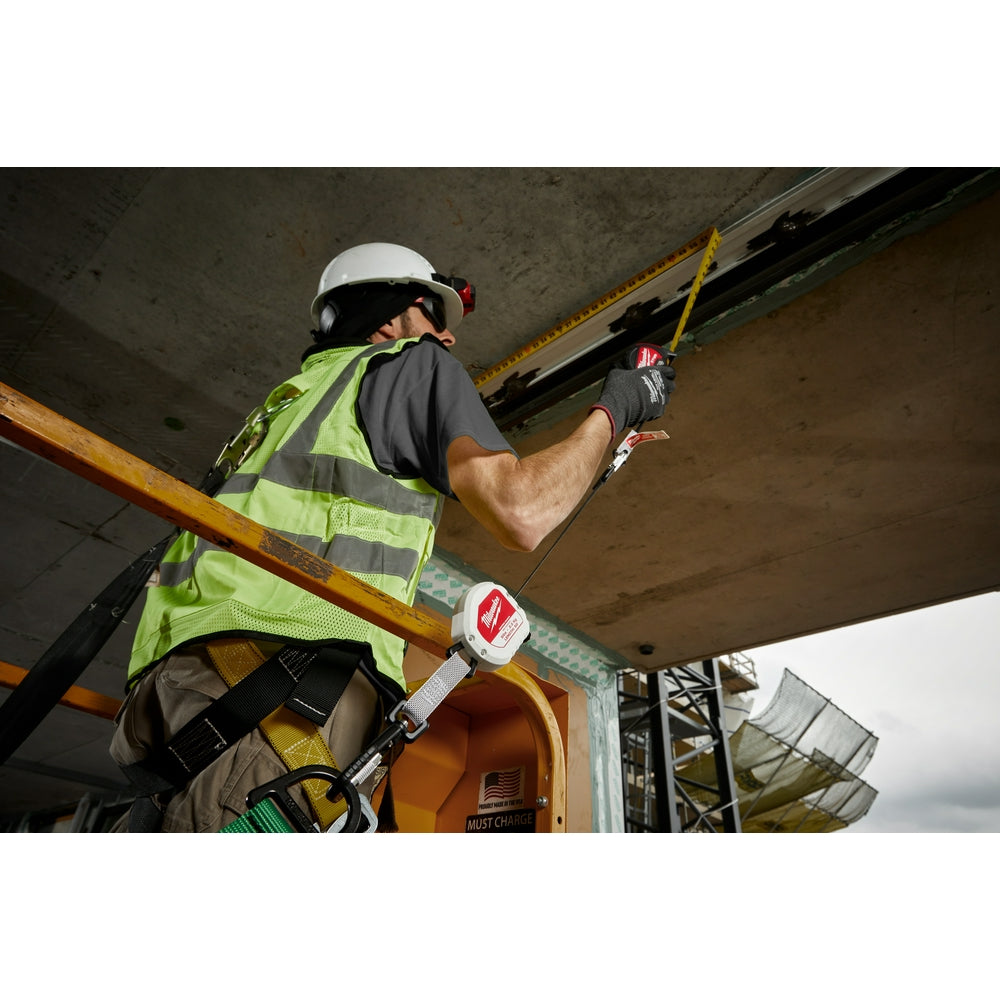 Construction worker wearing white hard hat and safety vest with retractable yellow tool lanyard attached to belt during overh