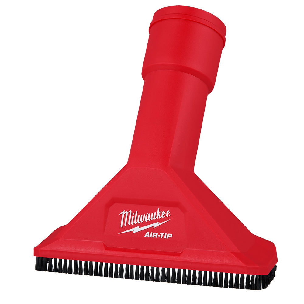 Red utility nozzle with black bristle brush strip along bottom edge and cylindrical attachment shaft.