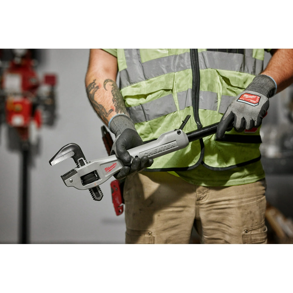 Milwaukee aluminum offset pipe wrench with adjustable jaw held in worker's hands wearing work gloves.