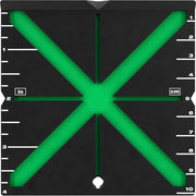 Black alignment target with bright green X-shaped crosshairs and measurement scales in inches and centimeters along the edges