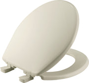 Biscuit-colored round plastic toilet seat with hinges and closed lid positioned at an angle.