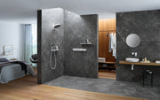 Matte white round shower head mounted on dark tile wall with handheld spray wand below.