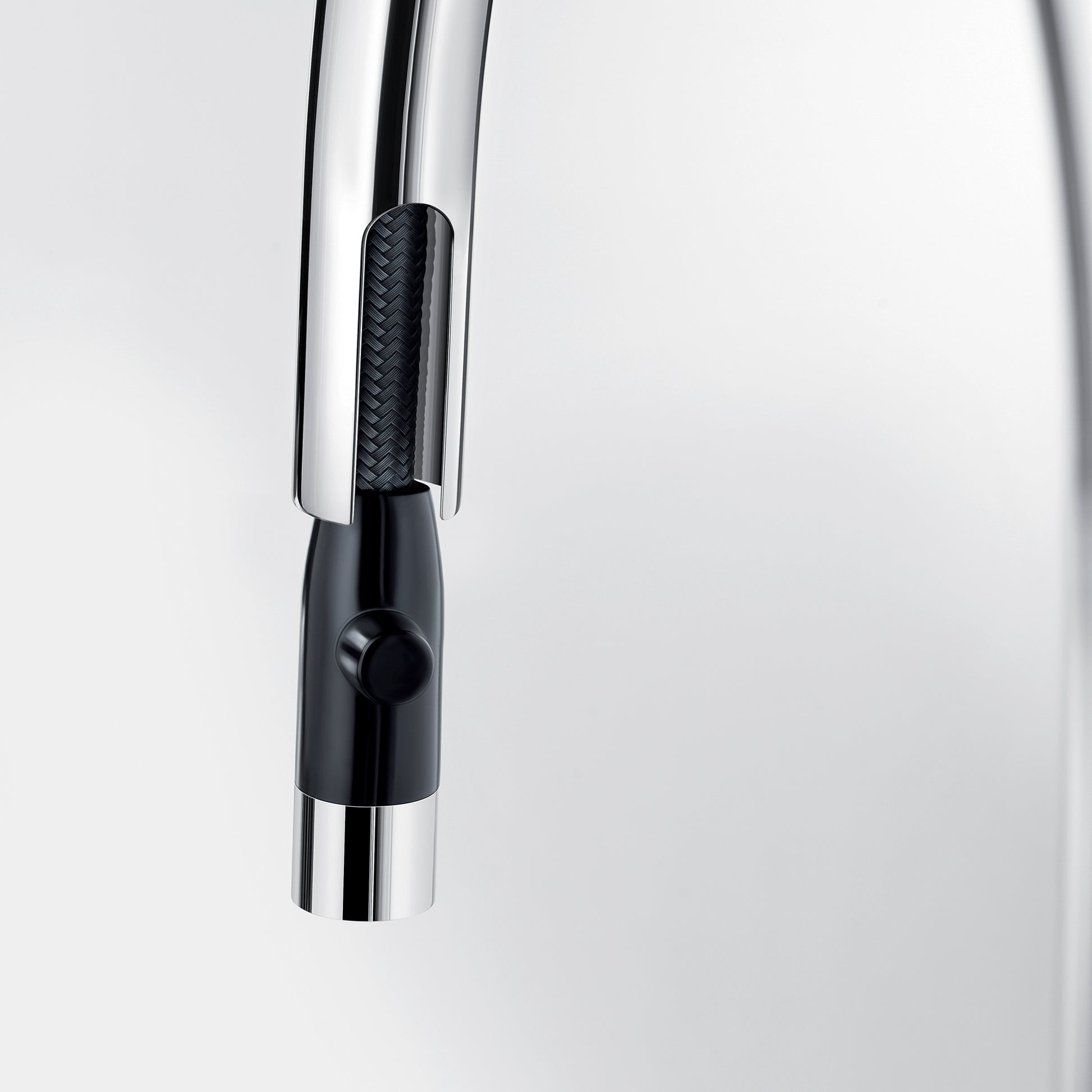 Chrome pull-down kitchen faucet with black grip handle and single control lever.