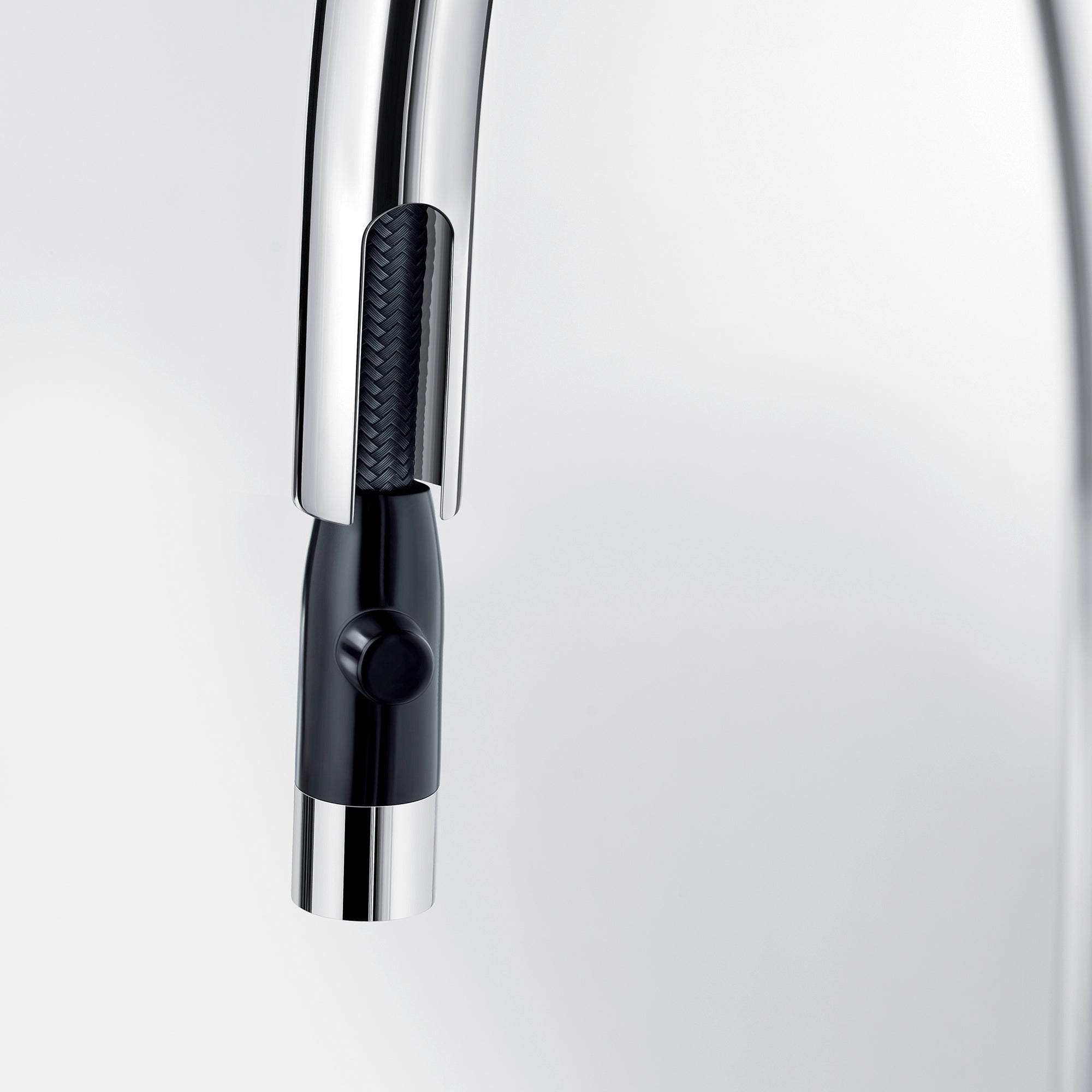 Chrome pull-down kitchen faucet with black grip handle and single control lever.