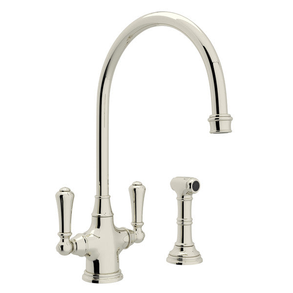 Polished nickel two-handle kitchen faucet with high arched spout and separate side spray attachment.