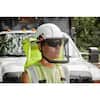 Black hard hat with full brim and yellow-green safety vest on construction worker.