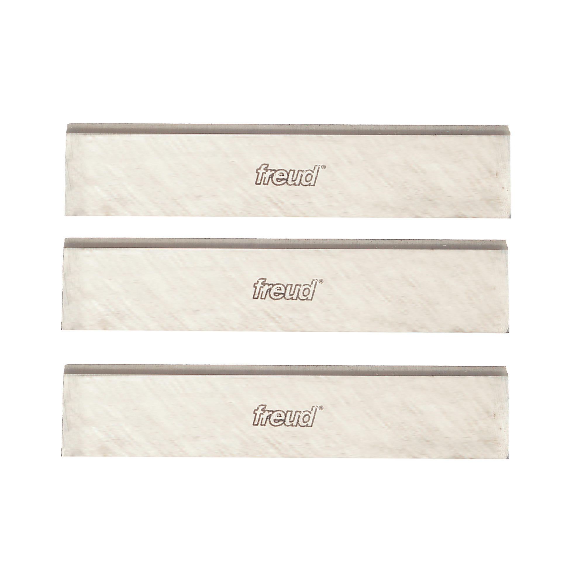 Three 4-inch Freud high speed steel planer and jointer knives with gray cutting edges and cream-colored bodies.