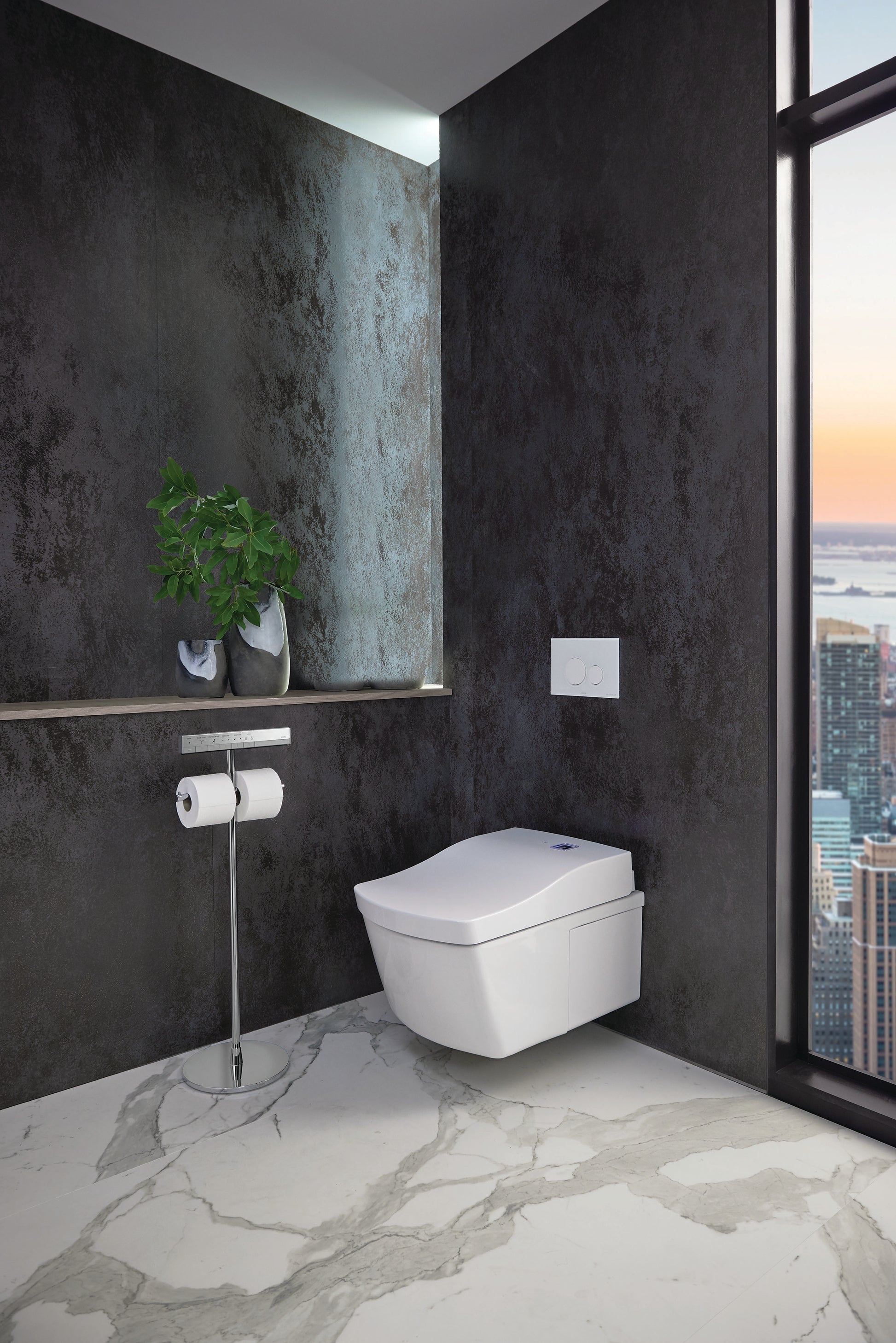 Polished chrome remote control stand mounted on bathroom wall beside white toilet.