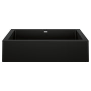 Coal black apron farmhouse sink with single rectangular basin and sloped front edges.