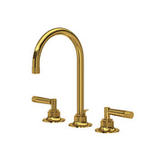 Unlacquered brass widespread lavatory faucet with curved C-spout and two lever handles.
