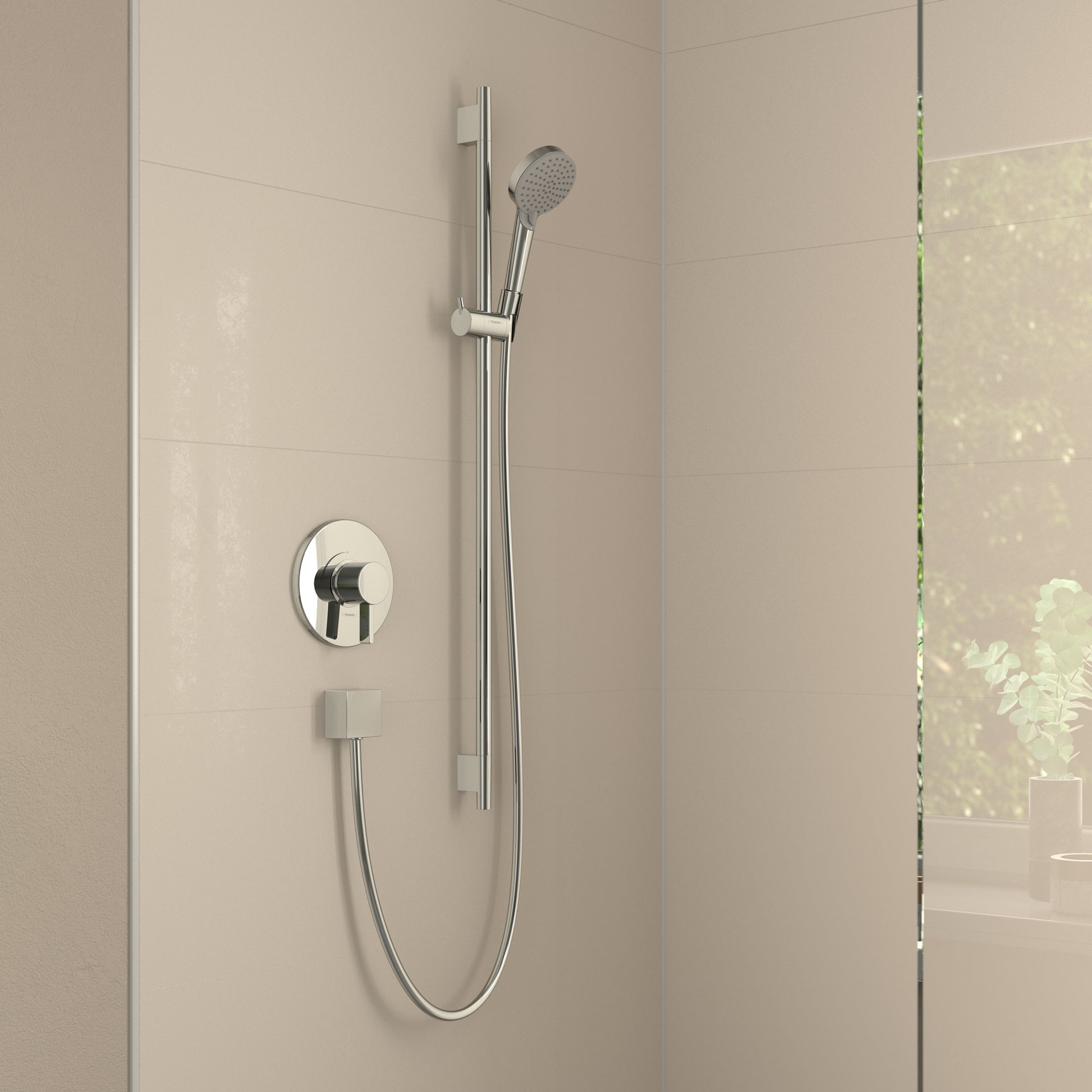 Chrome handshower with perforated head mounted on vertical rail with round wall-mounted control valve.