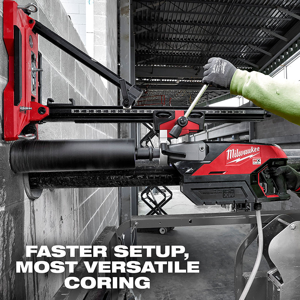 Red and black Milwaukee core drill stand with black cylindrical bit mounted horizontally on concrete wall.