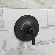 Matte black round pressure balance valve trim with single lever handle mounted on marble subway tile wall.