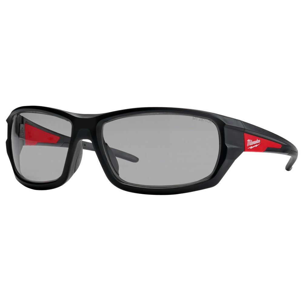 Black safety glasses with gray lenses and red accents on the temples.