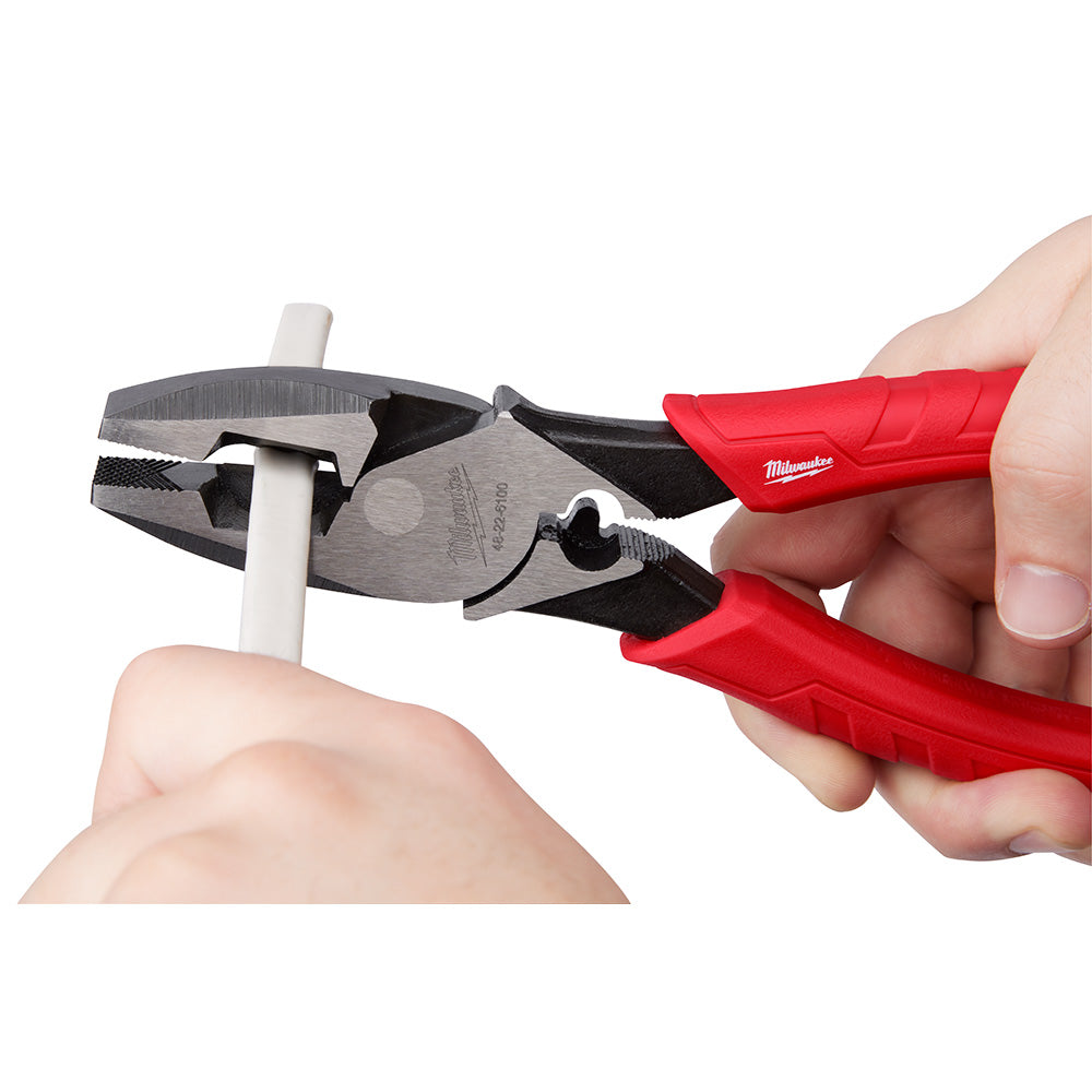 Milwaukee lineman's pliers with red handles held in hands, showing metal jaws and crimper feature.