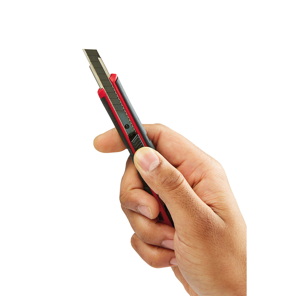 Red and black snap-off utility knife with 9mm blade held in hand against white background.