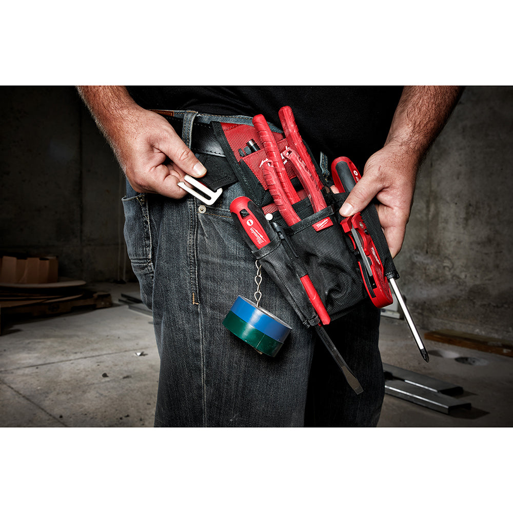 Black compact utility pouch worn on jeans belt with red tools and screwdrivers stored inside.
