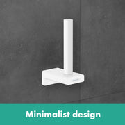 White toilet paper holder with vertical roll post mounted on gray tile wall.