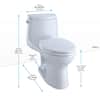 White elongated one-piece toilet with integrated tank, lid, and soft-close seat.