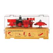 Five red and black router bits with various profiles displayed in clear plastic case with wooden base showing bit diagrams.
