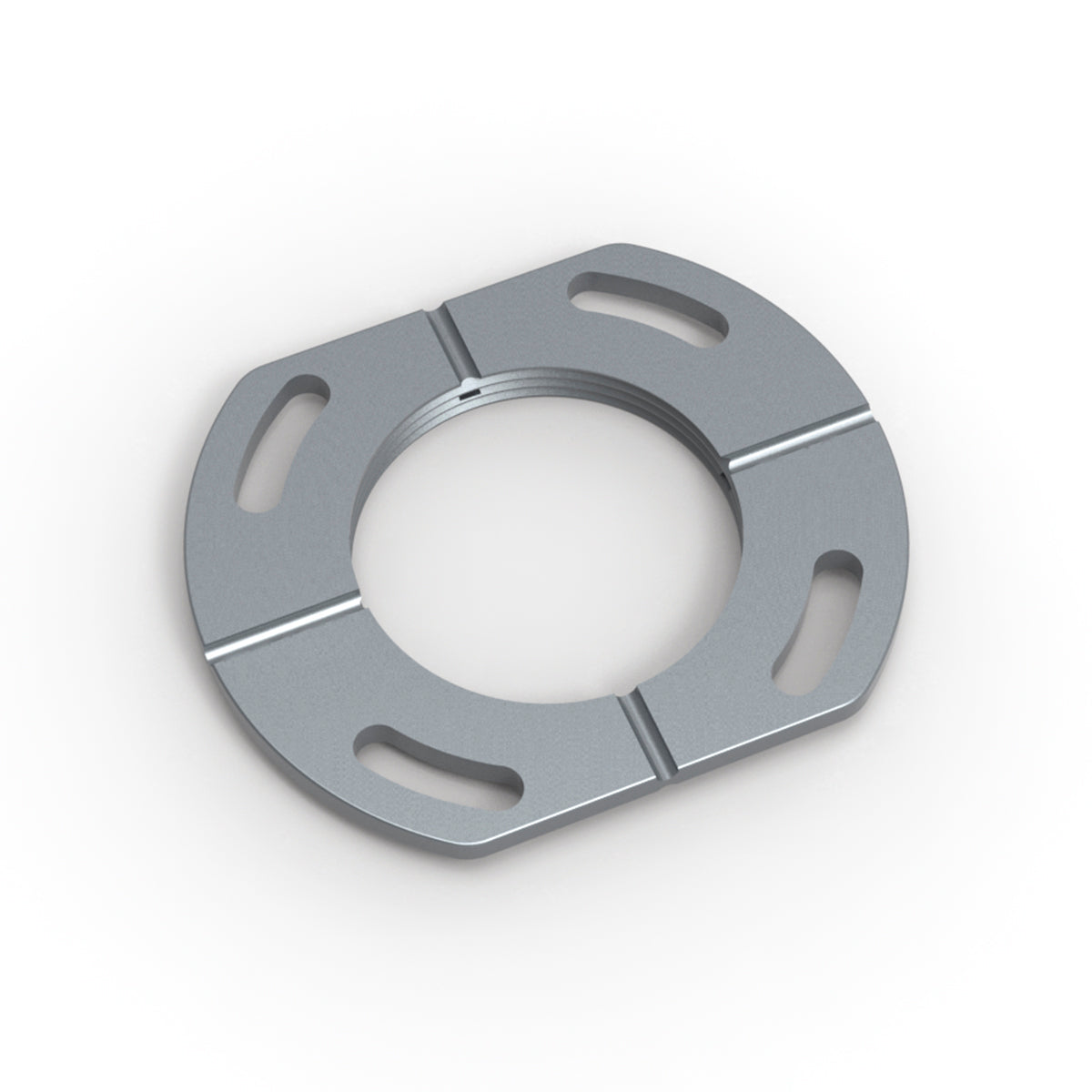 Gray metal drain component with central circular opening and four rectangular slots around perimeter.