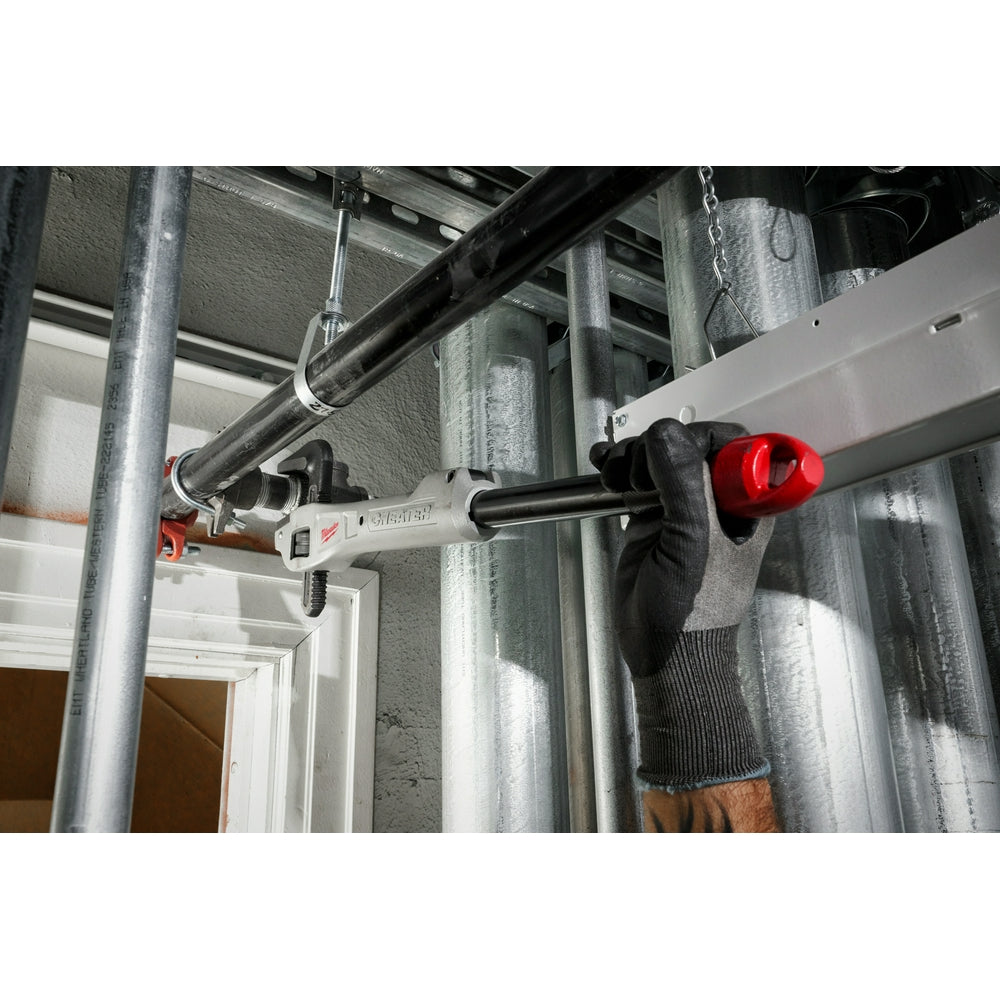 Aluminum offset pipe wrench with red handle gripping metal pipe during installation work.