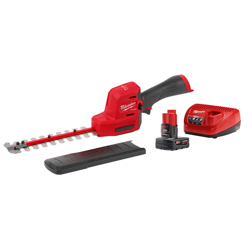 Red and black M12 FUEL hedge trimmer with battery, charger, and shoulder strap included.