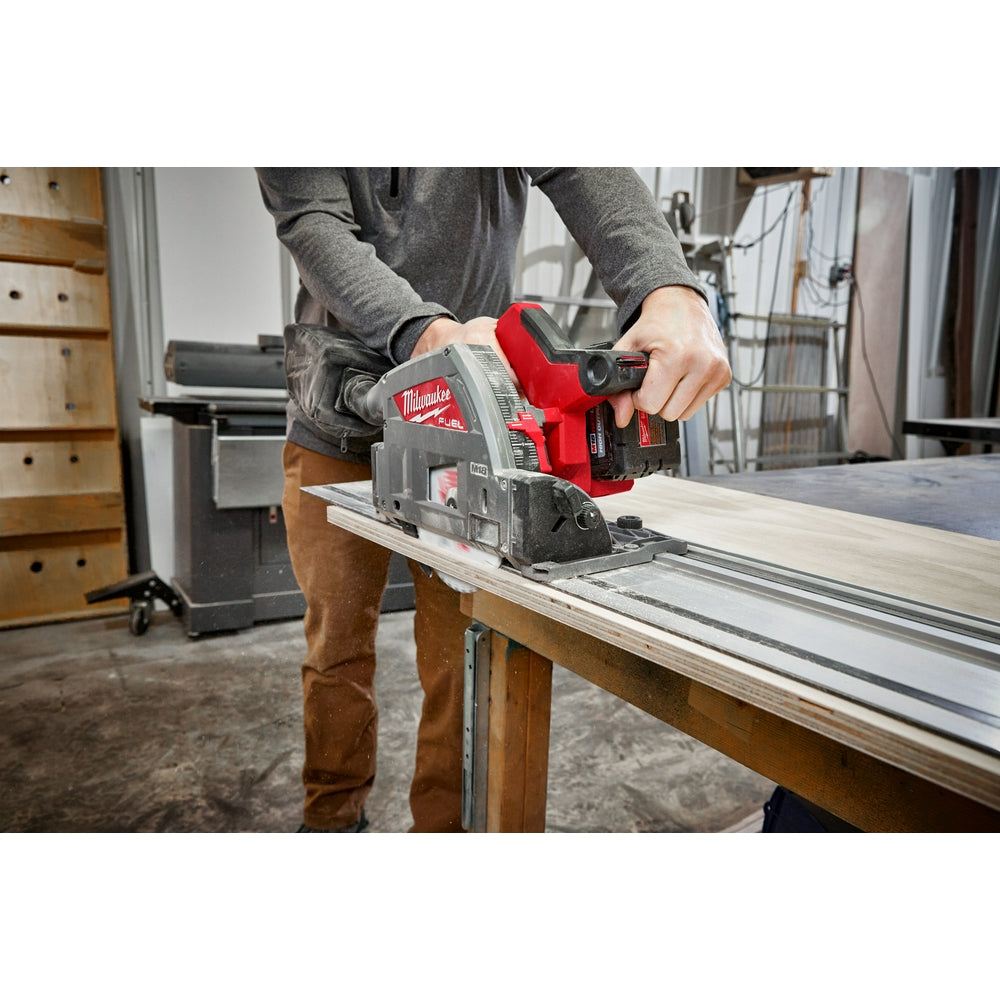 Black and red non-slip strip attached to Milwaukee circular saw guide rail during woodworking operation.