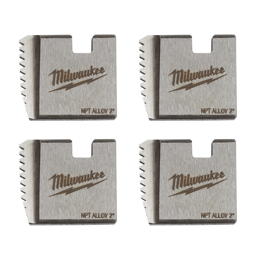 Four Milwaukee 2" NPT alloy pipe threading dies with serrated cutting edges and manufacturer branding on brushed metal surfac