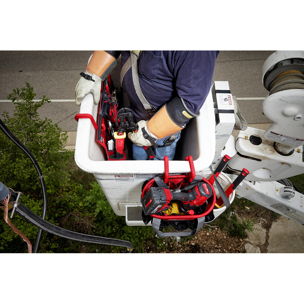 Red and black bucket hook attached to white bucket holding tools and equipment.