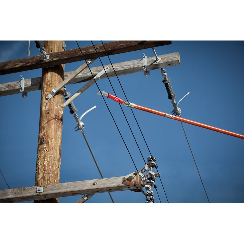 Utility pole with electrical lines and hardware against clear blue sky.