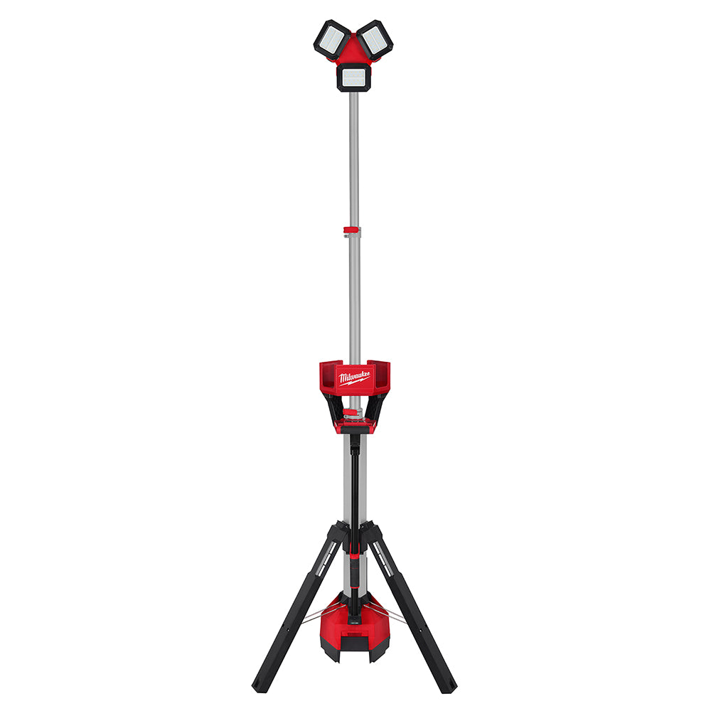 Red and black Milwaukee tower light with three adjustable LED heads on telescoping pole and tripod base.